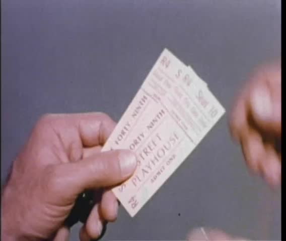 Close-up of male hands tearing ticket stubs