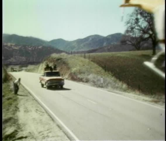 Director directing stunt car and helicopter scene in movie
