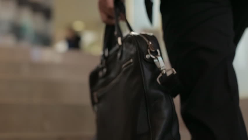 Businessman climbing stairs with a briefcase