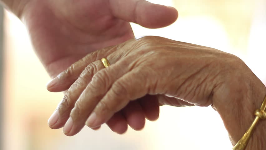 hd video of adult male hand hold senior female hand carefully/hold elder hand/adult male hold senior female hand close up