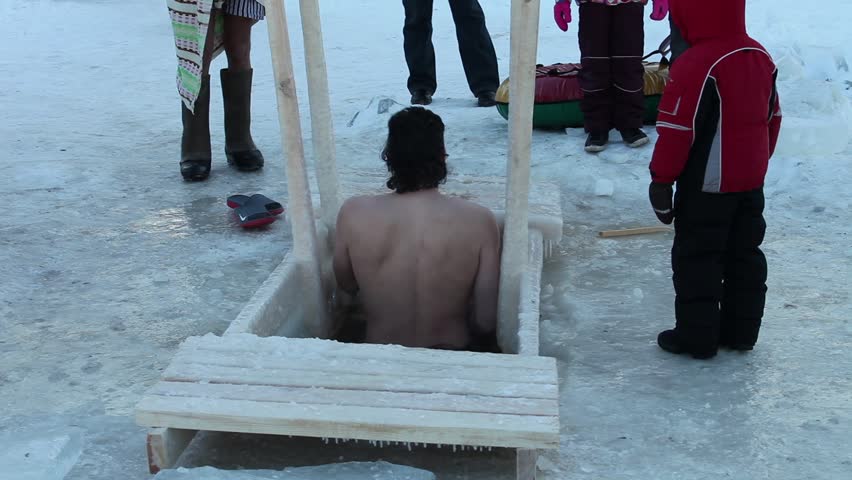 ST PETERSBURG - JAN 19: The Men  bathing  in an ice-hole on January 19, 2013 temperature of -14 degrees, the river Neva, St. Petersburg Russia