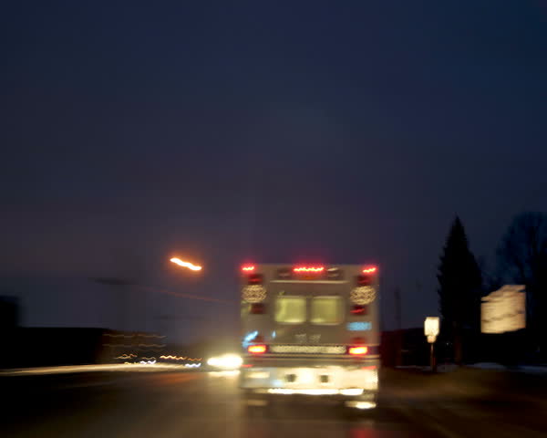 time-lapsed drive behind an on duty ambulance as it makes it's way through town to the hospital. Lights are on, but not flashing.