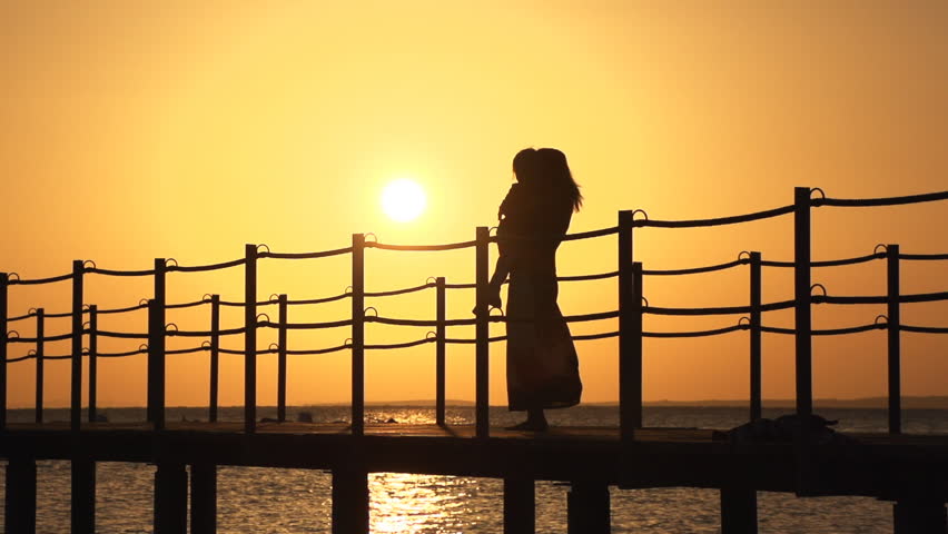 Mother and child circling on bridge. Super slow motion. December 25, 2012 in Sharm El Sheikh, Egypt.