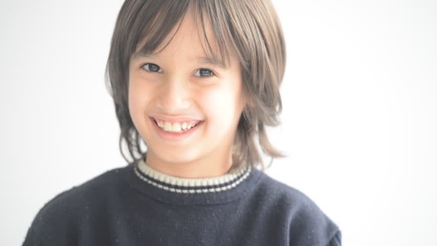 Cute little boy portrait, smiling to camera while wearing glasses