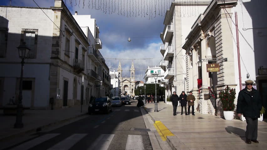 ALBEROBELLO, ITALY - DECEMBER 18: Street leading to Saint Cosma and Damiano Basilica on December 18, 2013, Alberobello, Italy. Alberobello is UNESCO World Heritage Site highly visited all year round