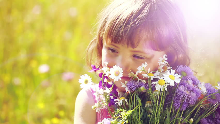 Sunny girl with flowers. Lens flares