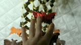 The man touches a beautiful garland up on a ceiling in honor of new year
