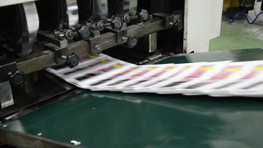 finished brochure magazine goes on the packaging line after it is printed on the web offset hit set press
