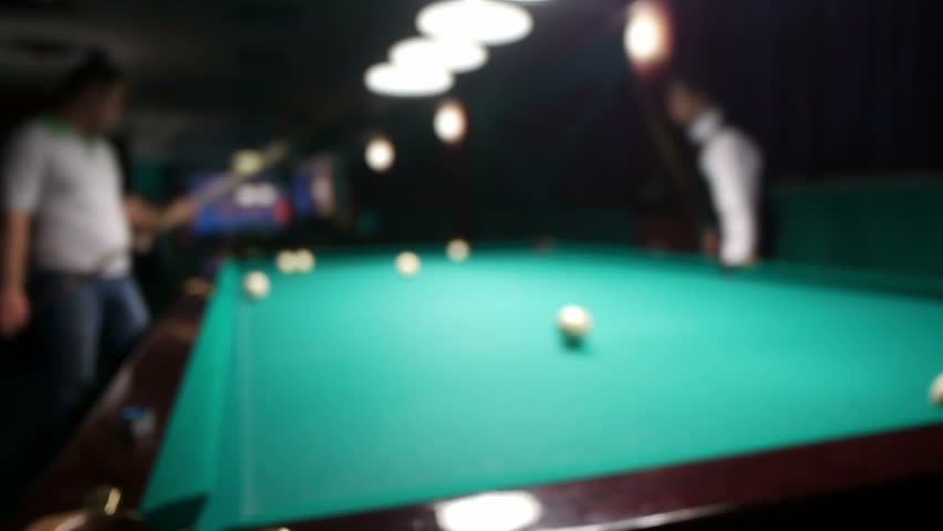 Playing russian billiard in a poolroom, defocused view