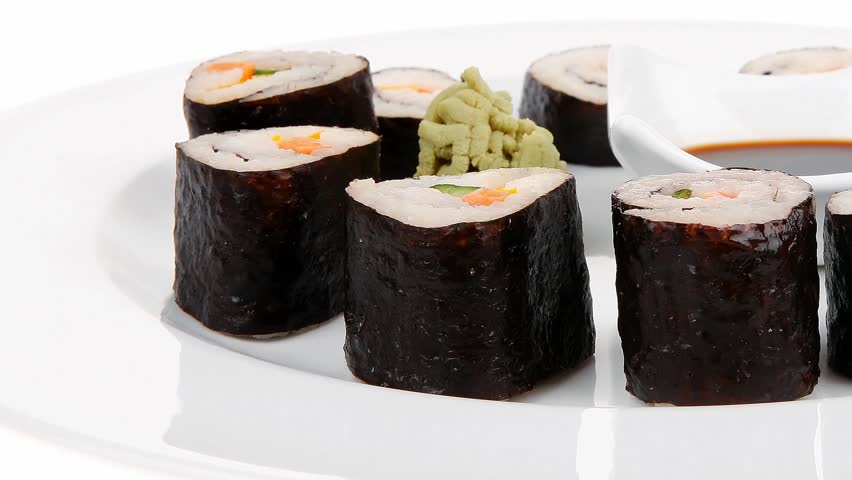 Japanese traditional Cuisine - Roll with Cucumber Cream Cheese with raw Tuna(maguro) and Salmon(sake) inside. on white dish with sticks hidef slow motion intro