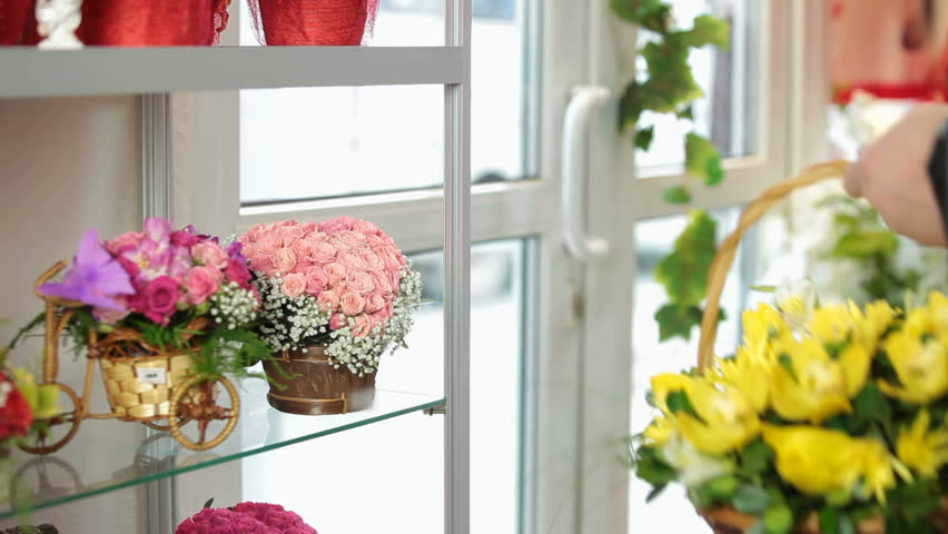 Customer Purchasing Flower Arrangement In Florist Shop