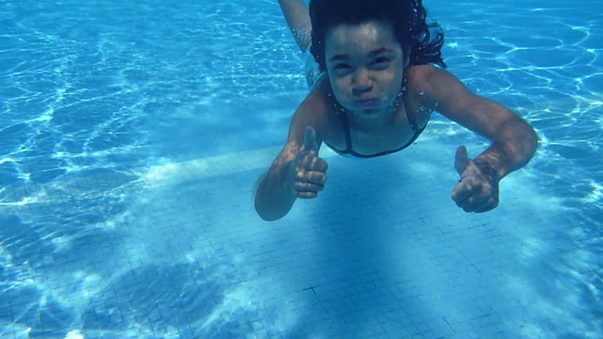 Happy active child in the swimming pool, underwater view