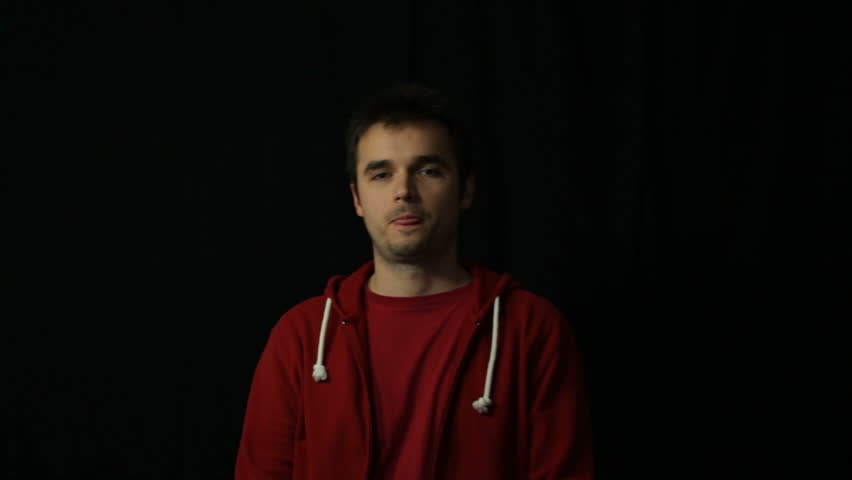 Confident Hip-Hop style man in red hoodie gesturing, studio isolated