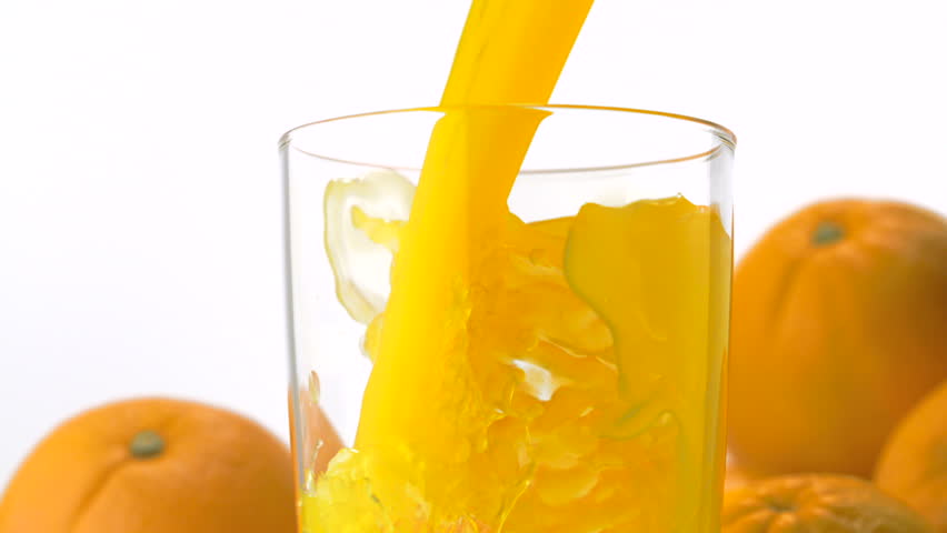 Pouring orange juice into glass shooting with a high speed camera.