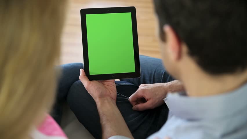 Couple looking at pictures on electronic tablet