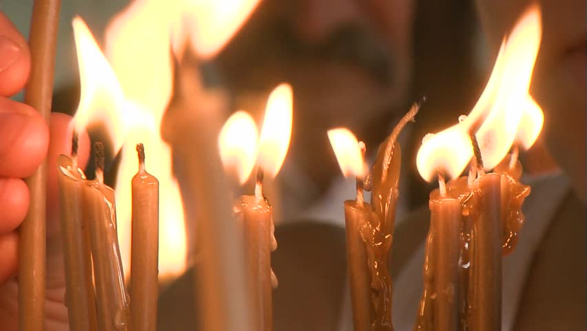 Orthodox Monastery Springhead original "Izvor", Serbia 2011.  August 8th. Faithful on the orthodox holiday dedicated St Paraskeva. Candle light close up shot