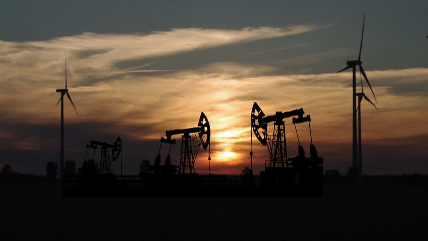 pump and wind turbine on sunset background 