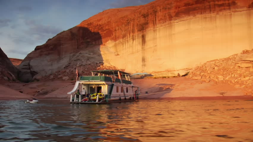 large houseboat docked in red rock Canyon Lake Powell Utah