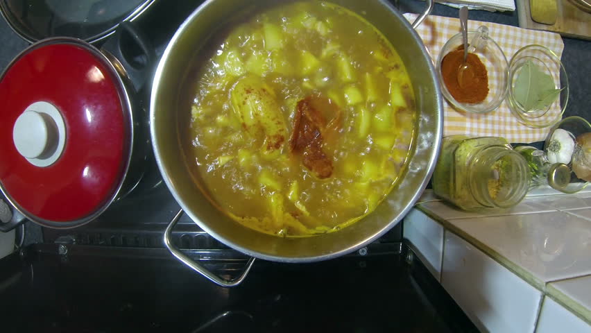Gourmet Cooking.
Chef adding cayenne pepper to a pot with chicken stew. HD1080p.