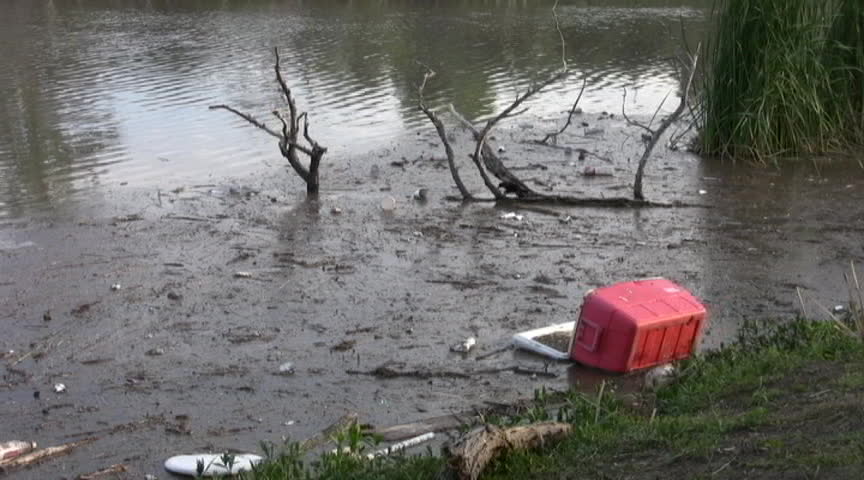 Video of a lake in downtown San Antonio Texas filled with junk and pollution. Near a local university. Don Despain of Rekindle Photo