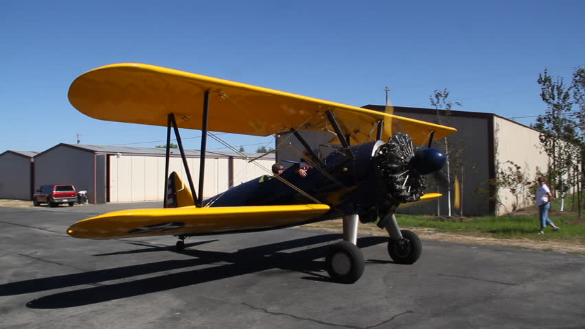 Stearman biplane taxis at airport during a nice day
