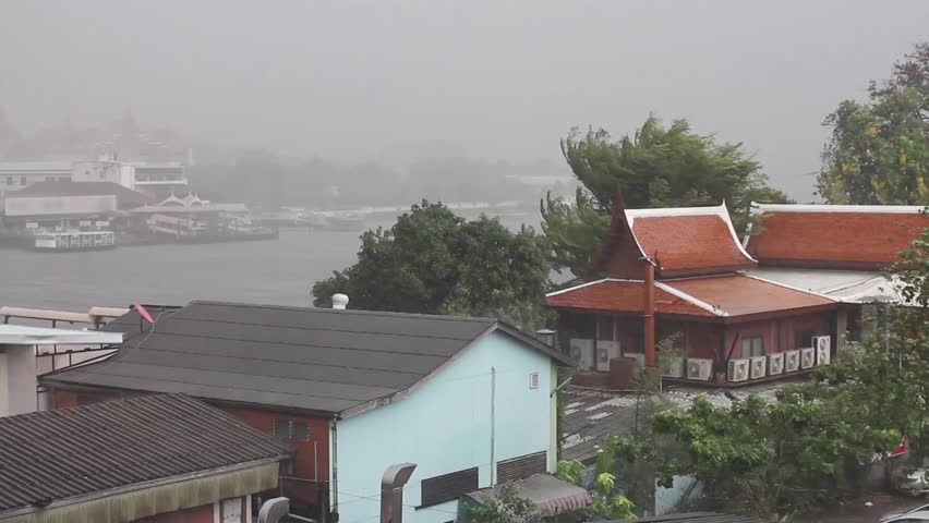 Heavy rainstorm near Grand Palace on March 15, 2013 in Bangkok, Thailand. Taxi boat on chaopraya river stop temporarily.