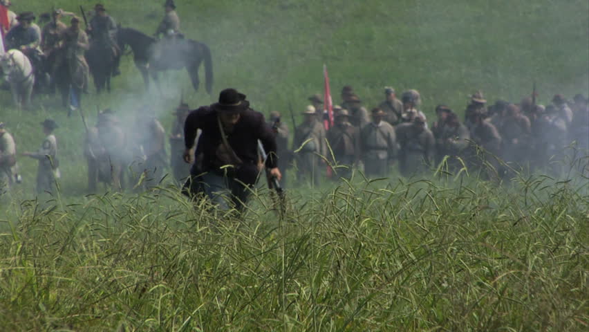 CHICKAMAUGA, GEORGIA - OCTOBER 2008 - large-scale, epic Civil War anniversary reenactment -- in the middle of battle.  Union Cavalry skirmishers run from the attacking Confederates as both are killed.