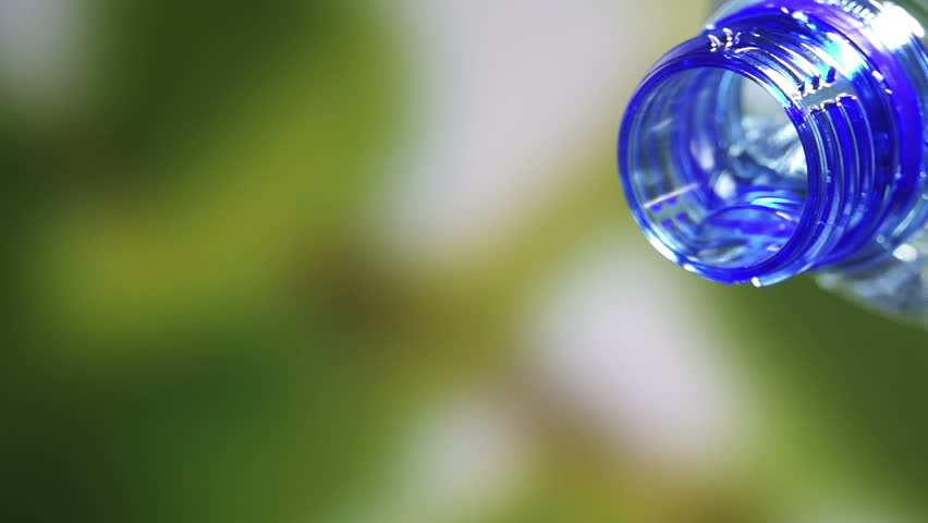 Fresh cool water pouring from a clean plastic water bottle.