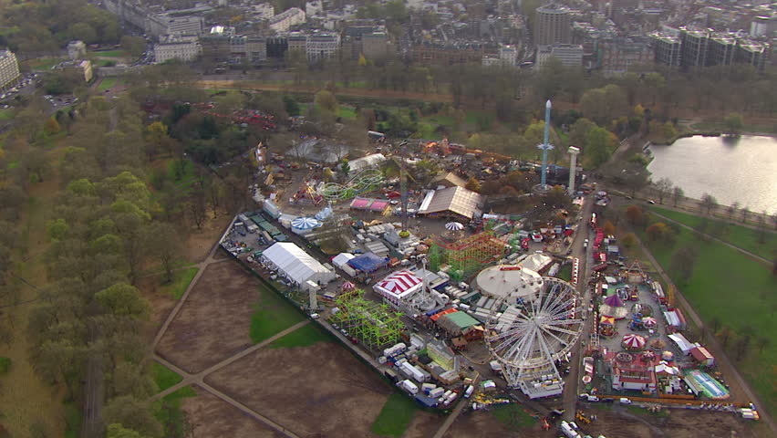 Aerial view of a fairground in London, England. It is situated in the middle of a large open space on the outskirts of the city.