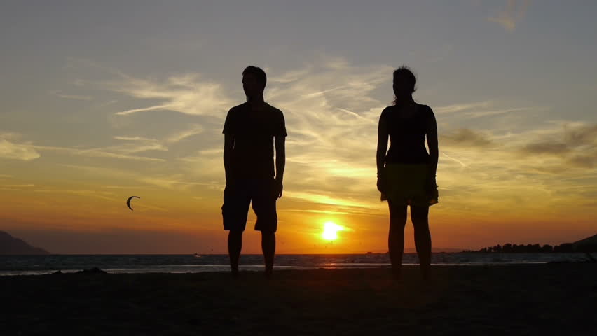 Couple jumping at sunset