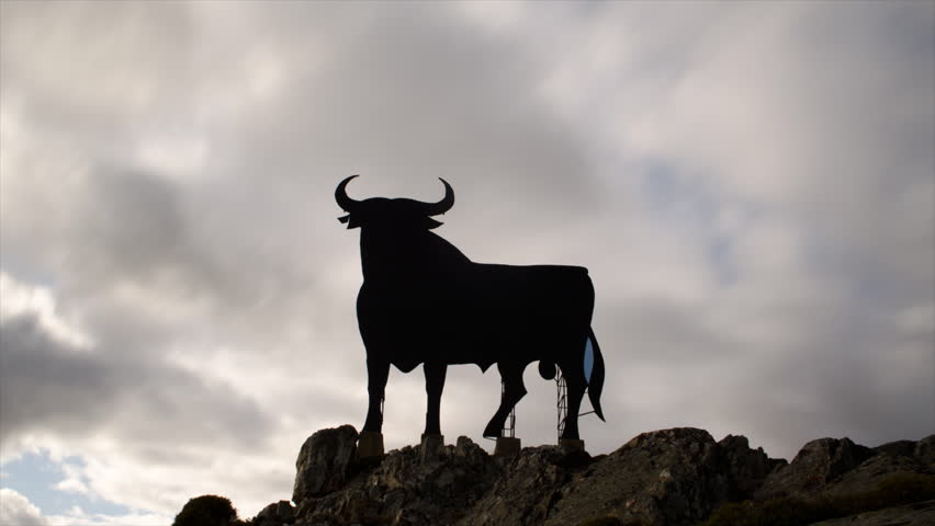 MADRID, SPAIN . CIRCA 2013: The (unofficial) national sign of Spain, the Osborne bull circa 2013 in Madrid, Spain. (Zoom in) Time lapse video.