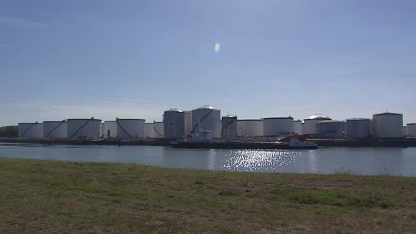 Gas and oil storage tanks and train with gas tanks + pan canal + sea vessel Port of Rotterdam, The Netherlands