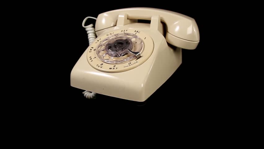White Rotary Telephone rotating over black background - looping video