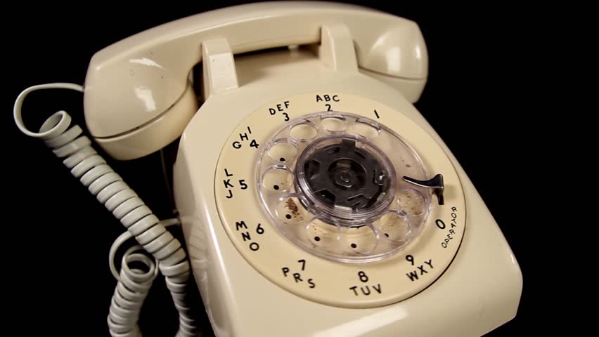White Rotary Telephone rotating over black background closeup - looping video