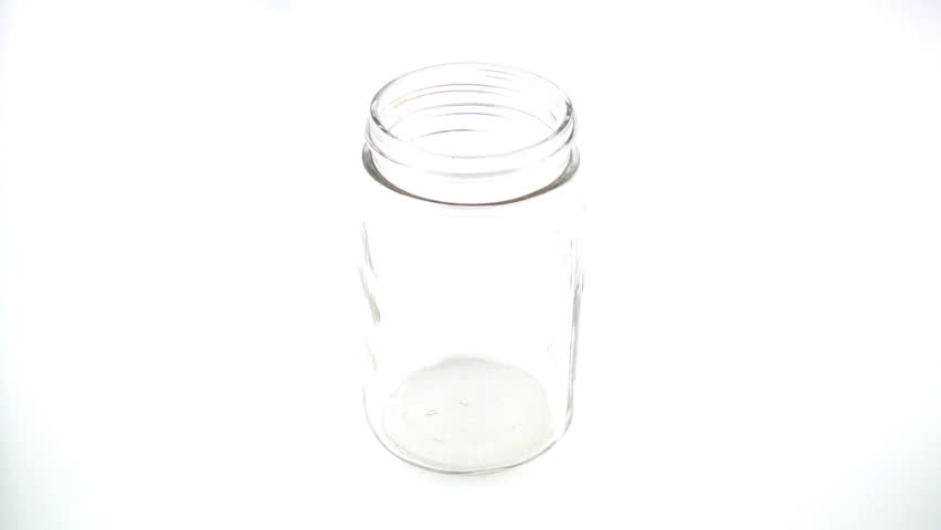 Pennies falling into a jar.