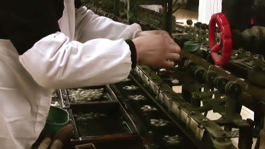 China. Factory for the production of silk and silk products. The work of the machine by unwinding the cocoon