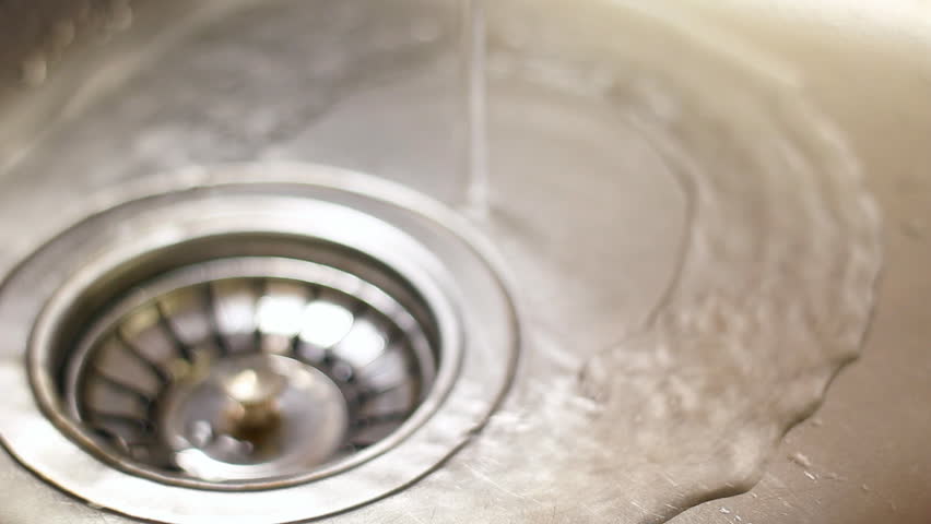 water flows from the tap into the sewer