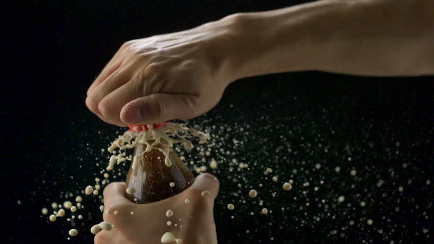 Bursting Coca cola bottle on black background shooting with high speed camera, phantom flex.