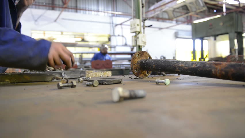 An industrial service repairmen labouring in workshop
