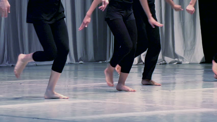 Contemporary choreography. Men and women dressed in black dancing barefoot. Slow Motion at a rate of 240 fps