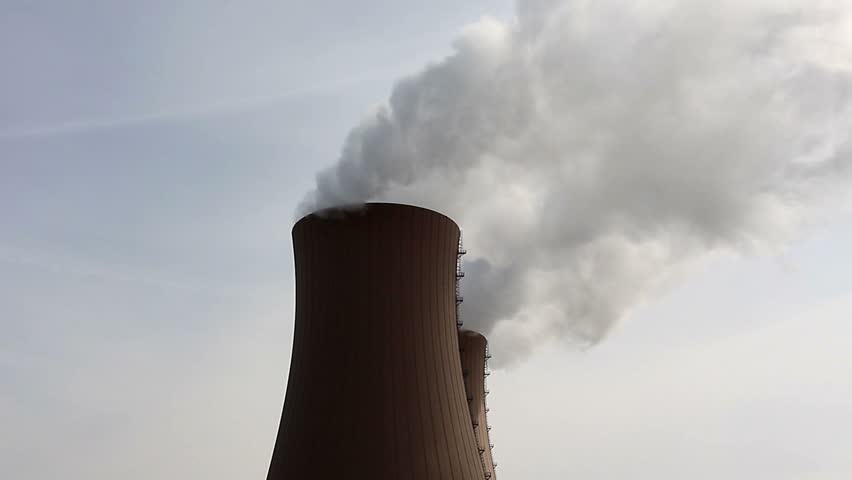Nuclear power plant and smoke against the sky