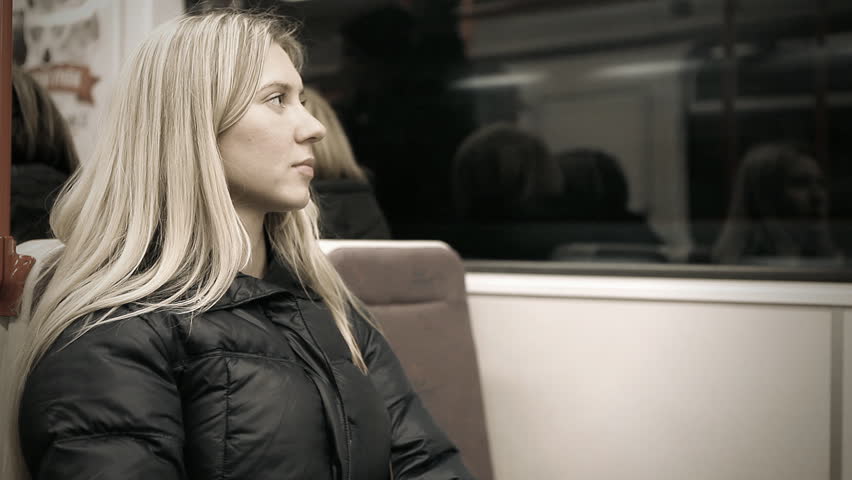 Beautiful young woman seat in empty subway