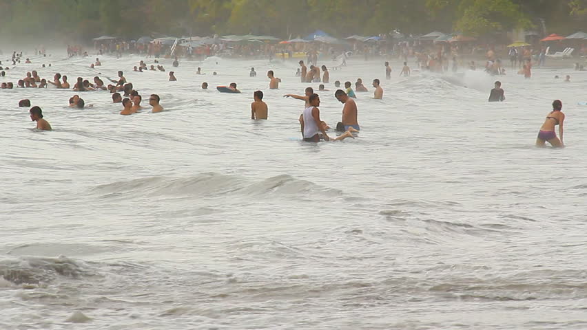 COSTA RICA - MAR 2013: Mostly local "Ticos" gathered on a beach just outside Manuel Antonio National Park in Quepos, Costa Rica in March, 2013.