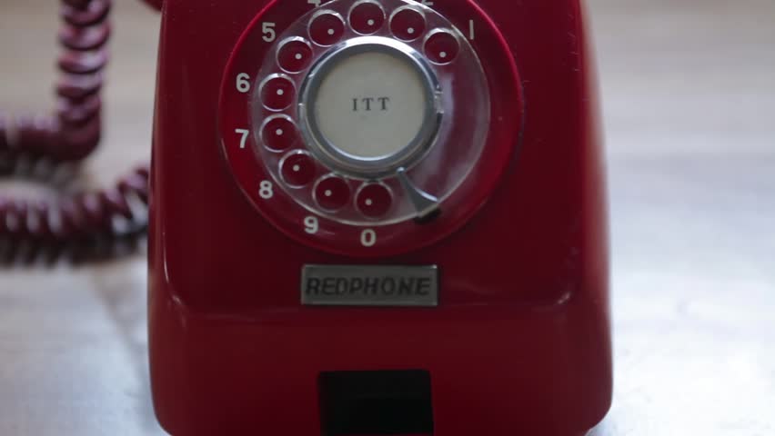 Close up dolly shot of old vintage rotary coin red phone