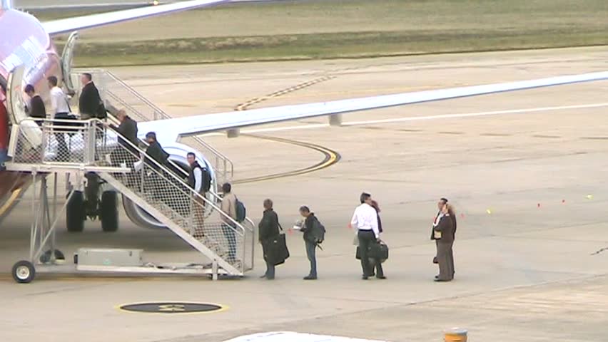 People board a passenger jet