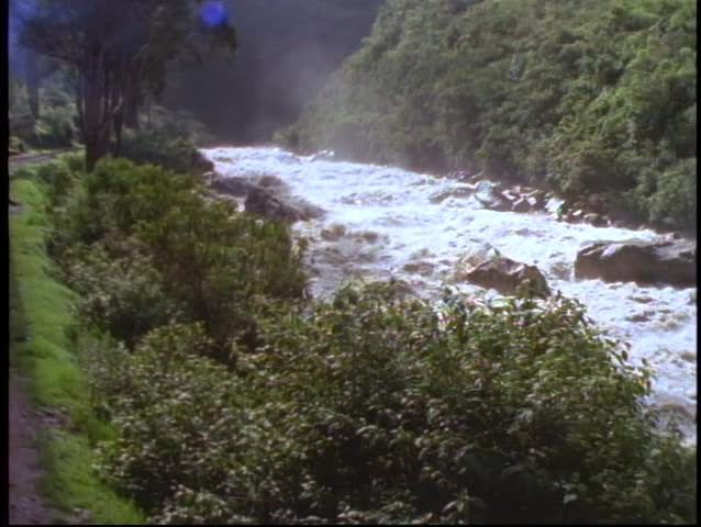 Peru, The Andes, train ride through Andes on narrow gauge, POV passing raging river