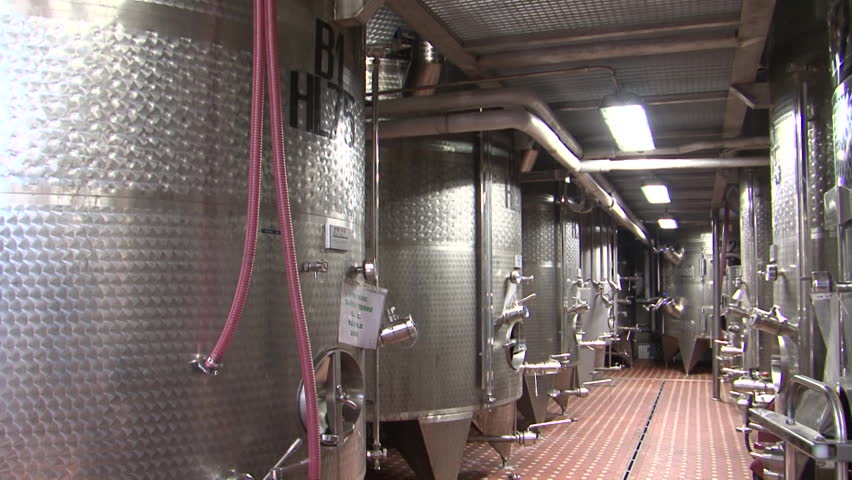 Stainless steel wine distilling vats at a large scale farm winery
