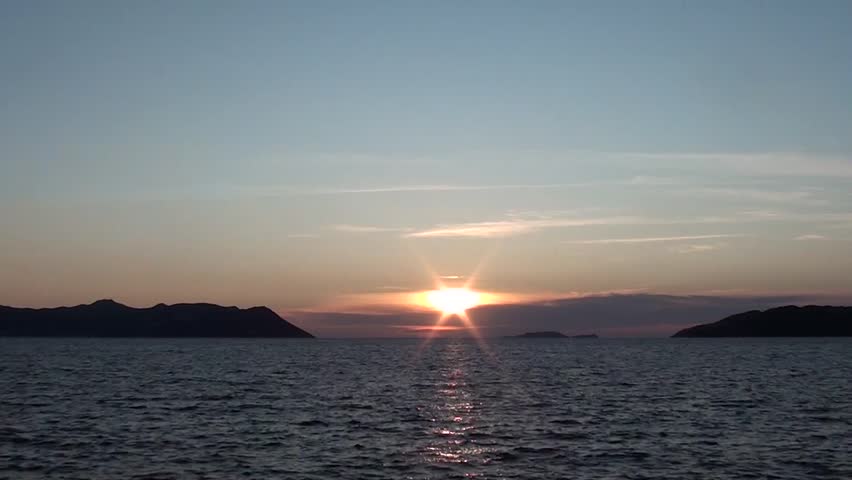 Sunset, sea, ripples waves, clouds, islands, mute