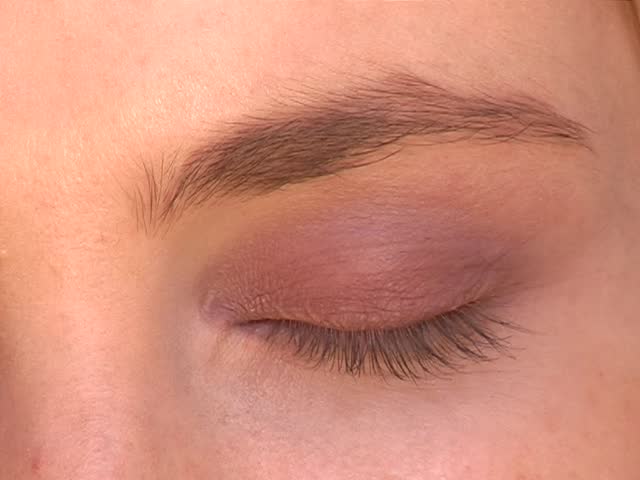 Make-up artist applying cosmetics to woman