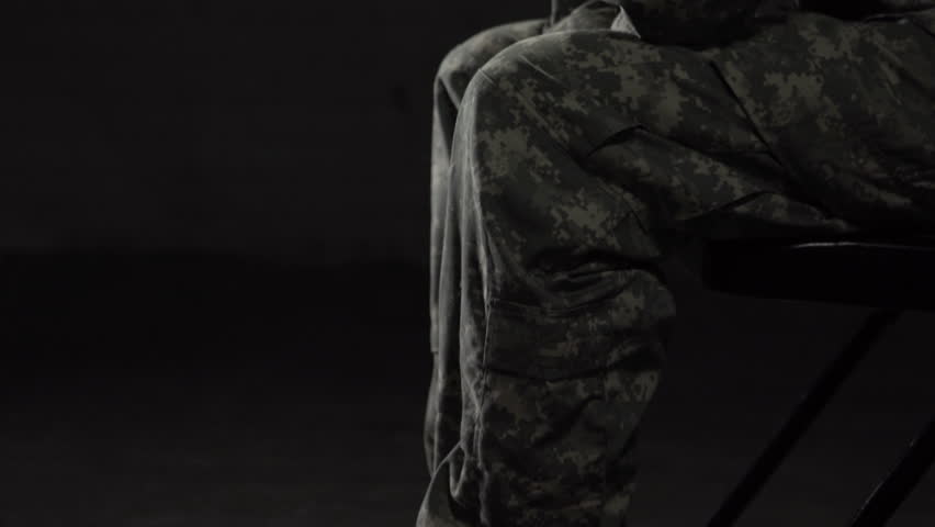 Military woman struggling with Post Traumatic Stress Disorder, looks at camera